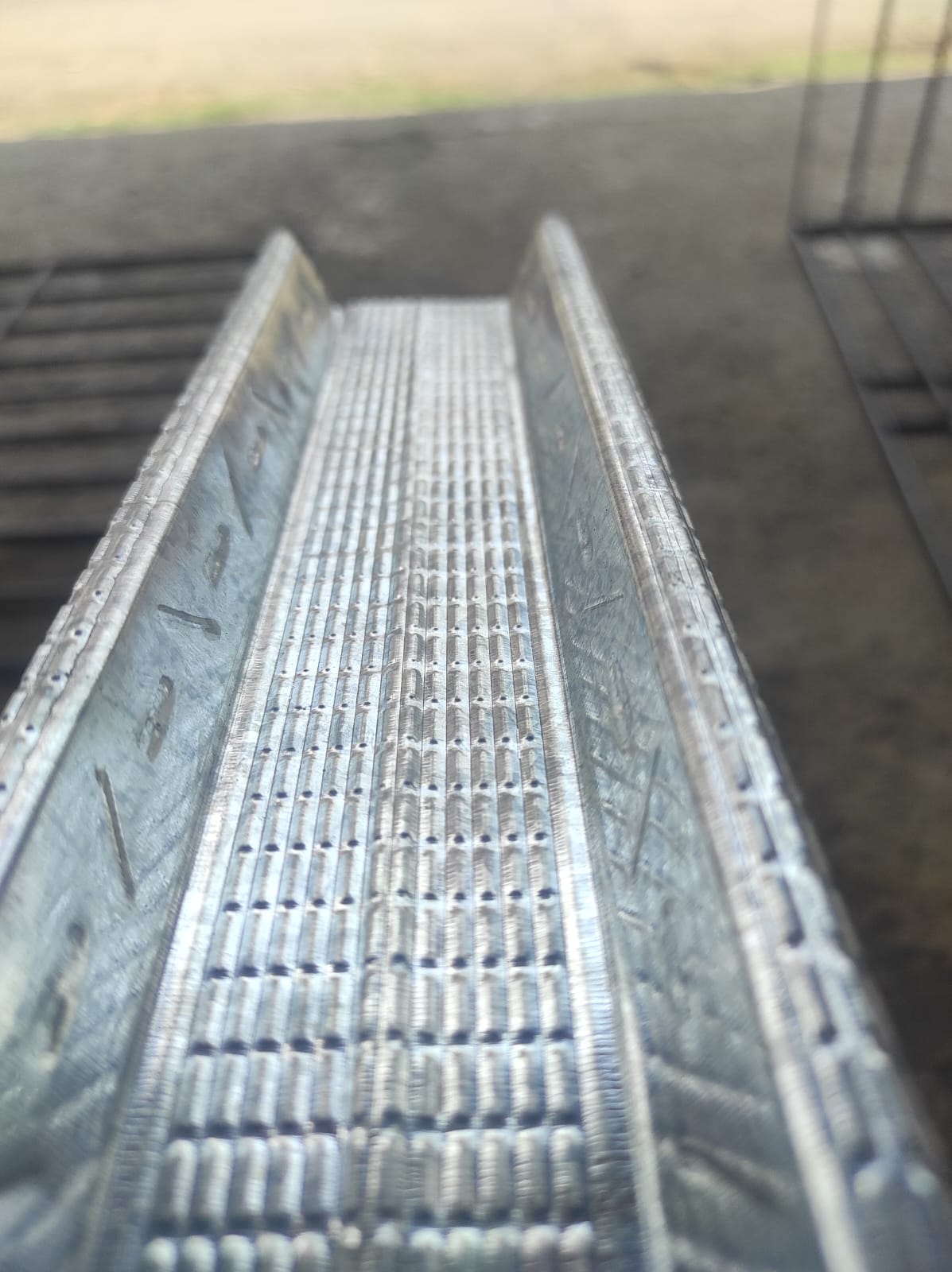 Inside view of galvanized C-channel with perforations